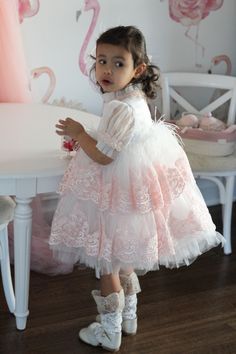 Petite Maison Kids. Gorgeous occasion dress in white color with peachy pink lace embroidery. Feathers on waistline. Faux Mother of Pearl beading. Multiple layers of tulle. Cotton lining on bodice. Back zipper closure. Evening Tulle Dress With Feathers, Pink Tulle Dress For Ceremony, Fitted Tulle Dress With Feathers, Embroidered Tulle Dress For Ceremonies, Formal Tulle Dress With Feather Trim, Ceremony Embellished Tulle Dresses, Tulle Party Dress With Feathers, Party Dresses With Feathers And Tulle Material, Party Dresses With Feathers And Tulle