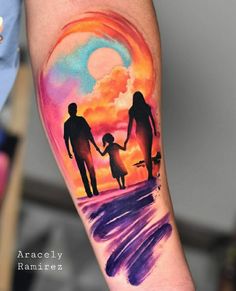 a colorful tattoo on the arm of a person with a child and an adult holding hands