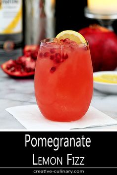 a lemon fizz cocktail with pomegranate garnish