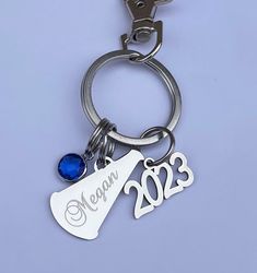 a keychain with a wine glass and a bottle opener on it's side