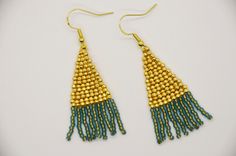 These are hand woven beaded fringe earrings. They are made with Japanese Toho seed beads in gold and a transparent frosted turquoise with a gold lining! These would go with just about any outfit! Gold Tassel Earrings With Tiny Beads, Gold Tassel Dangle Earrings With Tiny Beads, Gold Tassel Earrings With Beaded Fringe, Handmade Gold Tassel Earrings With Round Beads, Gold Beaded Earrings With Fringe, Gold Beaded Earrings With Fringe As Gift, Gold Beaded Fringe Earrings As Gift, Gold Beaded Fringe Earrings For Gifts, Jackson Wy