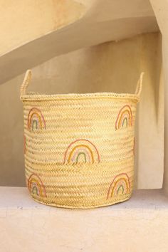 a woven basket with rainbows on it