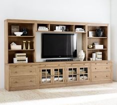 an entertainment center with bookshelves and a flat screen tv on it's side