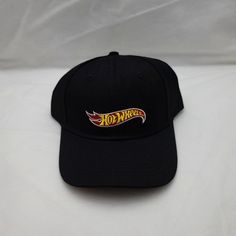 Brand New Without Tags. Adult One Size. This Black Baseball Cap Features The Iconic Hot Wheels Logo Embroidered On Its Front And Has An Adjustable Closure On Its Back. It Still Has The Cardboard Backing Inside The Cap As It Has Never Been Worn. *Final Price Drop; No Offers Will Be Sent/Accepted* ***Please Refer To The Pictures In Regards To The Wear And Condition As They Are Part Of The Description. Retro Black Dad Hat With Curved Brim, Retro Black Baseball Cap With Embroidered Logo, Black Retro Sports Baseball Cap, Retro Black Baseball Cap For Sports Events, Black Retro Hat For Sports Events, Wheel Logo, Black Baseball Cap, Open Road, Price Drop