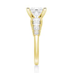 a yellow gold engagement ring with two princess cut diamonds