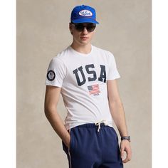 a young man wearing a usa t - shirt and shorts