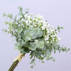 a bouquet of white flowers and green leaves