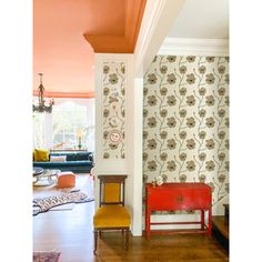 a living room filled with furniture and wallpaper