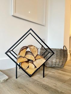 a stack of firewood sitting on top of a wooden floor next to a basket