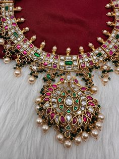 Jadau Kundan Multi Color Neckline Necklace with Emerald Beads with matching JhumkasColor : GoldenSize : Necklae Length : 14 Inches; No EarringsStones : Jadau Kundan Red Green Clear Jadau Kundan Emerald Beads Luxury Multicolor Kundan Necklace With Gemstones, Luxury Heavy Kundan Chandbalis, Luxury Beaded Kundan Temple Necklace, Multi Color Kundan Necklace, Luxury Gold Kundan Necklace With Gemstone Beads, Luxury Kundan Emerald Gemstone Necklace, Luxury American Diamond Kundan Necklace For Diwali, Luxury Multicolor Gemstone Kundan Necklace, Luxury Emerald Kundan Necklace In Temple Jewelry Style