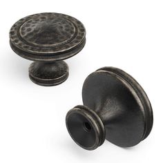 two antique style knobs and one is black with dots on the top, both are made out of cast iron