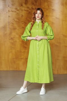 Calf-length dress in linen. Stand collar, buttons at front, long wide ruffled at bottom sleeves with narrow elastic at cuffs, which allows to raise the sleeve to 3/4 length. Pockets in side seams. Gently flared skirt. Unlined. FEATURES Name: Tacoma linen dress Color in the picture: citron Decor: plain Material: linen Length: ankle-length Clasp: buttons Collar: stand-up collar Sleeve length: long sleeve Sleeve style: trumpet sleeve Fit: relaxed fit Features: with pockets, with ruffles Season: summer Spring Long Sleeve Maxi Dress With Buttons, Long Sleeve Maxi Dress With Buttons For Spring, Spring Linen Buttoned Dress, Long Sleeve Maxi Dress With Button Cuffs For Daywear, Green Spring Dresses With Button Cuffs, Spring Green Dresses With Button Cuffs, Green Spring Dress With Button Cuffs, Spring Green Dress With Button Cuffs, Summer Linen Maxi Dress With Long Sleeves