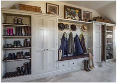 a room filled with lots of white cabinets and shoes on top of shelves next to each other