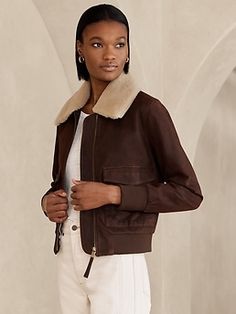 Up, up and away—this vintage-inspired pilot bomber is everything you could ask for.  With a removable shearling collar, the design offers more ways to style.  Crafted from exceptionally soft lambskin in a slightly oversized silhouette, this modern Chic Shearling Leather Jacket For Work, Classic Aviator-style Outerwear For Fall, Classic Aviator Outerwear For Fall, Aviator Leather Jacket With Padded Collar For Fall, Fall Aviator Leather Jacket With Padded Collar, Fitted Aviator Outerwear For Fall, Womens Moto Jacket, Faux Suede Moto Jacket, Burnt Umber