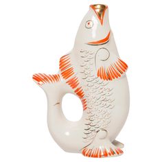 an orange and white fish figurine on a white background