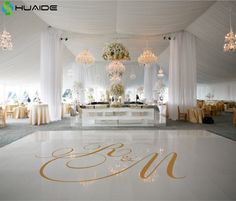 a white dance floor with chandeliers and decorations