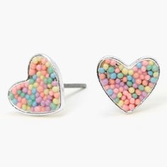 As sweet as candy, these pretty stud earrings will help you share your love with the world. Perfect for Valentine's Day or any day, silver-tone hearts are filled with multicolored pastel sprinkles Finish: Silver-tone Closure: Post back Material: Plastic - Claire's Silver Pastel Sprinkle Heart Stud Earrings Claires Piercing Earrings, Claires Heart Earrings, Claires Earrings Claire's, Claires Earrings Clip Ons, Pastel Rainbow Earrings, Claires Earrings, Unicorn Kids, Hand Necklace, Silver Jewelry Earrings