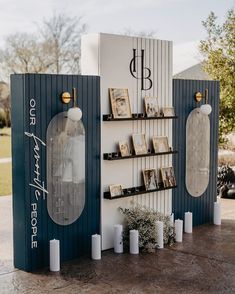 two display cases with pictures on them and candles next to each other in front of a building