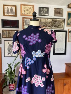 This is a gorgeous floral dress made in the 1960s. The fabric is a high-quality cotton and has a satin inner lining. Classic fit and flare silhouette. Item condition- this item is an incredible  condition. zipper is smooth and structurally it has no flaws. The left sleeve needs to be hemmed again but there are no stains or rips or other flaws. Size and measurements - Size Small Shoulders - 15 across (30) Bust - 18.5 across (37) Waist - 14.5   across (29)  Hips - 30 across (60) Length - 29 pit to Vintage Fitted A-line Floral Dress, 1950s Style Floral Print Dress For Vintage Fashion, Retro Vintage Dress With Floral Print, Retro Vintage Cotton Dress With Floral Print, 1950s Style A-line Vintage Dress With Floral Print, 1950s Style A-line Floral Print Dress, 1950s A-line Dresses With Floral Print, 1950s Style Floral Print A-line Dress, 1950s Style Floral Print A-line Vintage Dress