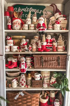 a shelf filled with lots of santa clause figurines and other christmas decorations on top of it