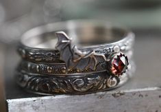 I made this set of 3 intricately patterned  solid sterling silver patterned rings with a sweet little vampire bat, also sterling.  I added a beautiful little genuine 4mm garnet, encased in a serrated sterling bezel.  Widths of bands vary from 2mm-3.5mm. SIZING HINT:  I'd advise ordering 1/2 size up for this wider ring stack if you want to wear them all together, it's much more comfortable to wear. The sterling silver has been darkened/antiqued then polished to bring out the patterns.  Any size. Vampire Ring, Little Vampire, Vampire Wedding, Bat Ring, Couples Ring, Gothic Ring, Couples Ring Set, Vampire Bat, Witchy Jewelry