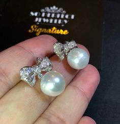 We are presenting you A PAIR OF matching SOUTH SEA PEARLS with LUSTROUS WHITE color. SET IN HANDCRAFTED, 18K SOLID GOLD DROP EARRINGS. ACCENTED WITH 64 E/VS, SPARKLING ROUND BRILLIANT DIAMONDS! IN CASE OF RETURN FOR US BUYERS. BUYERS MAY SEND THE ITEMS BACK TO OUR US-BASED OFFICE IN SALT LAKE CITY, UTAH ONLY ONE ITEM AVAILABLE!! NO DUPLICATES!! WHAT YOU SEE IN THE PICTURES IS WHAT YOU WILL GET SOLIDLY HANDCRAFTED EARRINGS! SUGGESTED RETAIL VALUE: $9,880 PEARLS: Size: 12 mm Shape: Oval/Round Colo Luxury Pearl Earrings In Diamond White For Formal Occasions, Luxury Diamond White Pearl Earrings For Formal Occasions, Luxury Pear-shaped Diamond White Bridal Earrings, Luxury Diamond White Pear-shaped Bridal Earrings, Luxury Diamond Pearl Earrings For Wedding, White Brilliant Cut Jewelry For Evening, White Bridal Earrings With Diamond Accents For Evening, White Cubic Zirconia Evening Jewelry, White Bridal Drop Earrings With Diamond Accents