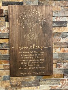 a wooden plaque with an image of a tree on it and the words john & mary written in gold ink