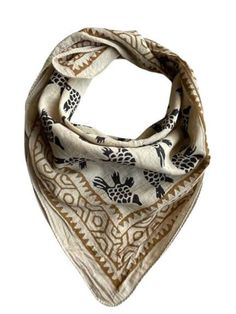 a white and brown scarf with black pineapples on it's sides, in front of a white background