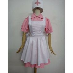 a mannequin wearing a pink and white dress with a red cross on it