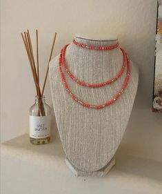 This bracelet and necklace duo is a beautiful coral pink with gold detail beads.  Necklace is 15 inches. Adjustable Coral Jewelry With Tiny Beads, Adjustable Single Strand Coral Beaded Necklace, Adjustable Coral Beaded Single Strand Necklace, Adjustable Coral Single Strand Beaded Necklace, Coral Necklaces With Gold Beads For Gifts, Multi-strand Coral Beaded Necklace As Gift, Multi-strand Coral Beaded Necklace For Gift, Coral Multi-strand Beaded Necklace For Gift, Adjustable Coral Beaded Necklace As A Gift