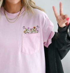 Comfort Colors Embroidered crewneck wildflower pocket tshirt. Embroidered flower shirt. Flower Boho Shirt. Gift for her or Girlfriend Gift. PLEASE NOTE THAT THE PICTURES ON THE LISTING ARE SAMPLES ONLY. If interested in adding embroidery to the sleeve please go to this listing: https://www.etsy.com/listing/1674502020 Because it is made to order, we don't accept the return or exchange unless we make a mistake We are unable to replace or refund purchases based on the color and the font selections. Spring T-shirt With Pockets And Relaxed Fit, Pink Cotton T-shirt With Pockets, Summer Crew Neck T-shirt With Pockets, Short Sleeve Tops With Pockets For Spring, Summer Graphic Tee With Pockets, Cute Pink Top With Pockets, Pink Cotton Tops With Pockets, Pink Casual Tops With Side Pockets, Spring Pink Tops With Side Pockets