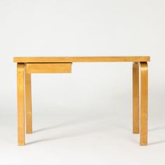 a wooden table with two drawers on it's sides, against a white background