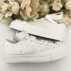 Stunning all white low Converse Platform, faux leather with gold hints, beautifully embellished with : - Fully embellished toe caps and back strips with Pearls and Swarovski crystals - Pearls and Swarovski crystals embellished on the outsides of the shoes in a spray gradual fade effect starting from the front and fading to the back - Finished with Beautiful full satin laces Available with all 4 sides of the shoe embellished with pearls or just the outsides of the shoes embellished (2 sides) (This photo shows 2 sides) Platform Converse Wedding, White Low Converse, Pearl Converse, Low Converse, Converse Wedding, Bridal Converse, Converse Custom, Converse Platform, Pearl Bride