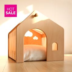 a wooden dog house with a bed in the middle and a hot sale sign above it