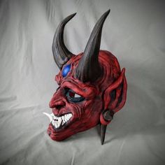 Red Goblin Oni style Noh mask Based off traditional Japanese Noh Masks. Made of PLA and hand painted in acrylics. This mask is large enough to be wearable by most people. Comes as mask only without straps. Inside dimensions are: 240 H x 160 W mm/ 9.5 H x 6.25 W in Overall Dimension: 340 H x 200 W mm/ 13.5 H x 8 W in Each piece is individually made to order so keep in mind: It will possibly take a couple weeks to paint and get it shipped out. The paint and coloring may differ slightly the picture Artistic Red Masks And Prosthetics For Costume, Traditional Red Masks And Prosthetics For Costume, Traditional Red Costume Masks And Prosthetics, Artistic Red Mask For Costume, Traditional Cosplay Masks And Prosthetics, Traditional Cosplay Masks, Traditional Halloween Masks And Prosthetics, Red Halloween Masks And Prosthetics For Festival, Handmade Red Masks And Prosthetics For Masquerade