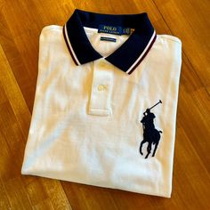 White Polo With Blue Collar, Blue Trimmed Sleeves, And A Big Blue Pony Logo On Left Chest. Custom Slim Fit. Nwt Mint Condition. Nh5fe4x4sa3s Red Polo Shirt, Polo Shirt Colors, Polo Pullover, Polo Ralph Lauren Shorts, Ralph Lauren Polo Shirts, White Polo, Thermal Shirt, Ralph Lauren Shorts, Cotton Polo Shirt