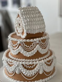 a three tiered cake is decorated with white lace and icing on a table