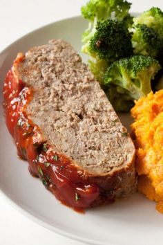 meatloaf, mashed potatoes and broccoli are on a white plate