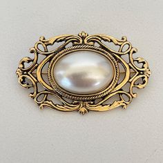 Vintage Brooch Faux Pearl Cabochon  Gold tone metal  Please see pictures for size and details Formal Metal Brooch Pin, Vintage Style Formal Brooch Enamel Pin, Vintage Formal Enamel Pin Brooch, Antique Metal Brooch For Formal Occasions, Happy Valley, Antique Brooches, Vintage Stuff, Vintage Brooch, Gold Tone Metal