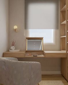 a desk with a chair, lamp and window in a room that has wooden shelves