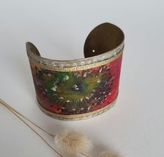 This cuff bracelet is made of hand-painted silk with floral pattern. I painted a red flower with a green and gold pistil on the silk ribbon. * bronze and silk colored metal * width 5 cm * Hand painted floral pattern * High quality French paintings *Heat fixed to preserve colors * Made in Lyon * red, green, bronze * bohemian It's the perfect useful gift to give to please Birthdays gift idea, christmas gift idea Sending : beautifully packaged in an organza bag and in a black gift box sent by colis French Paintings, Bohemian Bracelet, Painted Silk, Bohemian Bracelets, Hand Painted Silk, Black Gift Boxes, Black Gift, Flower Bracelet, Red Flower