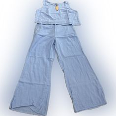 Women’s 2pc Pants Suite. Wide Legs. Sleeveless. Light Blue. Large. Casual Light Blue Sets With Pockets, Casual Wide Leg Two-piece Bottoms Set, Casual Two-piece Set With Wide Leg Bottoms, Casual Wide-leg Two-piece Bottoms Set, Casual Two-piece Pants For Vacation, Blue Two-piece Pant Set For Spring, Casual Spring Matching Pant Set, Casual Spring Pant Set, Casual Spring Vacation Pant Set