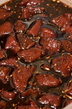 a pot filled with meat and sauce on top of a stove