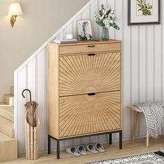 a wooden cabinet sitting next to a stair case