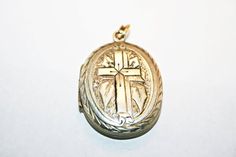 Antique Victorian silver locket, circa 1890s. In good condition, with minor wear and dings commensurate to age; along one edge of the cross, there is a hairline gap in the engraving, where the instrument used to emboss the locket's surface split through the metal. See photos for condition and measurements. Antique Collectible Crucifix Jewelry, Antique Crucifix Collectible Jewelry, Antique Collectible Cross Jewelry, Victorian Engraved Crucifix Jewelry, Vintage Antique Silver Cross Pendant, Silver Cross Pendant For Wedding, Vintage Antique Silver Cross Jewelry, Vintage Cross Jewelry With Antique Finish, Vintage Engraved Cross Jewelry