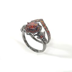 a ring with red and orange stones on it