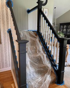 a stair case with plastic covering it and a clock on the top of one handrail