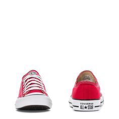 a pair of red sneakers with white laces