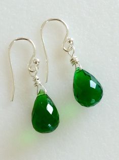 "Gorgeous faceted Emerald green Quartz teardrops wire wrapped in Sterling silver. Lush green briolettes measure 9 x 13 mm and hang from simple classic Sterling silver French ear hooks. They measure 1 1/8\" long. Beautiful May birthstone earrings!" Green Teardrop Drop Earrings Nickel Free, Green Nickel-free Teardrop Drop Earrings, Green Faceted Teardrop Earrings, Green Nickel-free Teardrop Earrings, Green Teardrop Earrings For May Birthstone, Green Teardrop May Birthstone Earrings, Green Teardrop Jewelry With Ear Wire, Green Wire Wrapped Long Drop Earrings, Green Wire Wrapped Long Drop Jewelry