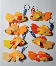 several different types of felt fish hanging from hooks